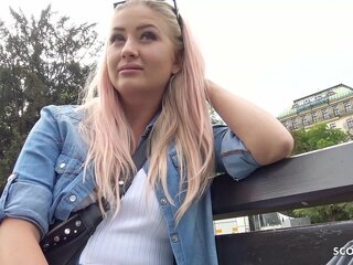 A German model auditions for adult entertainment on the street, revealing her curvy figure and engaging in a sexual conversation